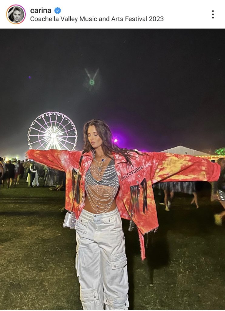 Festival Outfit Inspiration  a Woman Standing Outside at a Music Festival at Night Wearing a Body Chain Top 
