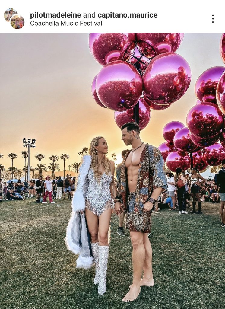Festival Outfit Inspiration  a Couple Standing Outside with Giant Pink Balloons Behind Them the Woman Wearing a Shine One Piece and a Long Trench Coat