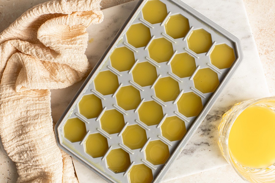 Sunrise Strawberry Mimosa Recipe Overhead View of an Ice Tray Filled with Orange Juice