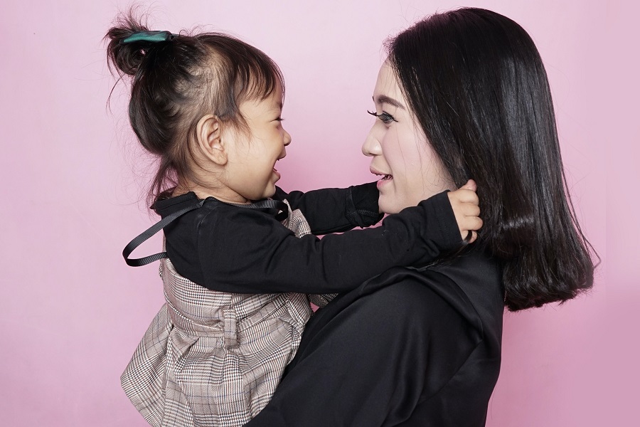 Mother's Day Brunch Decor Ideas Mother Holding Her Daughter Looking at Each Other Smiling