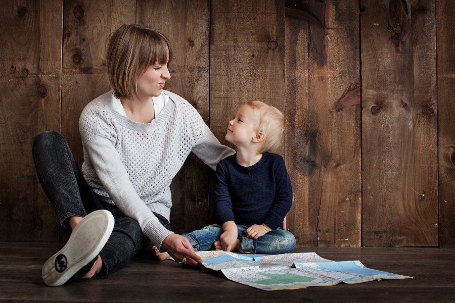 Mother's Day Brunch Decor Ideas a Mother Sitting on the Floor Against a Wall with a Baby Looking at a Book