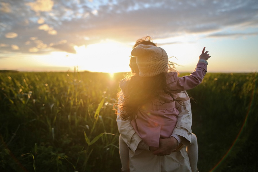 Mother's Day Brunch Decor Ideas a Mother Walking Through a Field at Sunset Holding a Little Girl