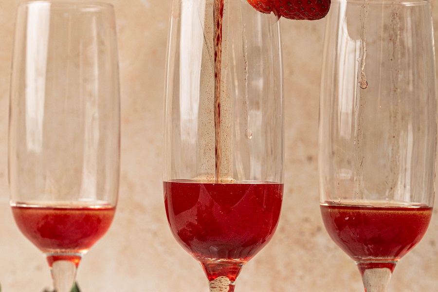 Sunrise Strawberry Mimosa Recipe Close Up of Champagne Flutes with Strawberry Simple Syrup