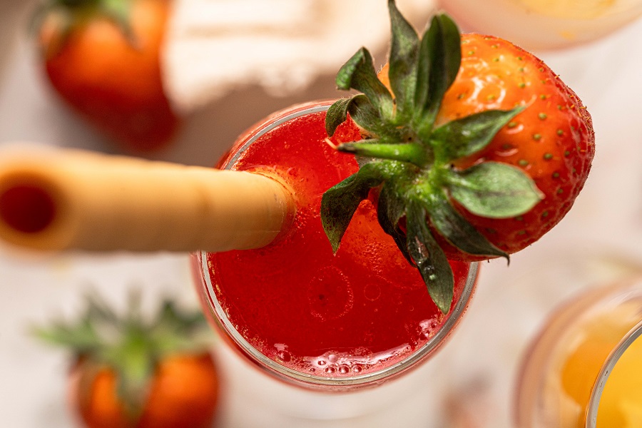 Sunrise Strawberry Mimosa Recipe Overhead View of a Champagne Flute with Strawberry Sunrise Mimosa Inside