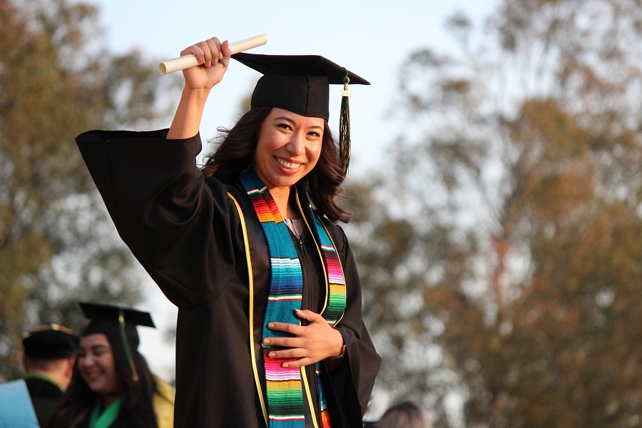 Graduation Gift Ideas a Female Graduate Holding Up Her Diploma 
