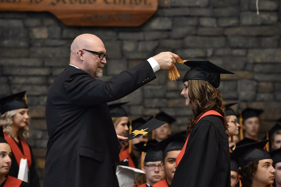 Graduation Gift Ideas a Female Graduate Getting Their Diploma from the School Leader