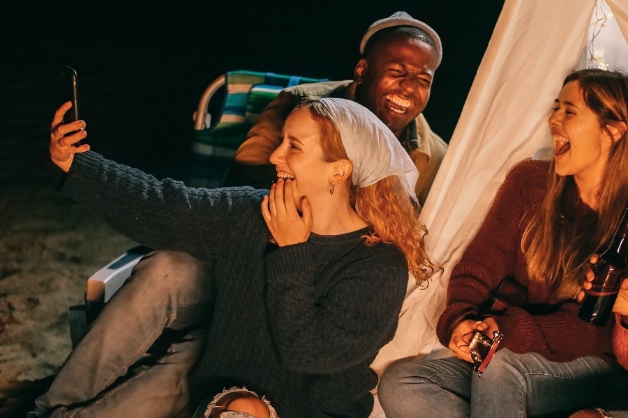 DIY Outdoor Lighting People Gathered Together Laughing Sitting Outside at Night