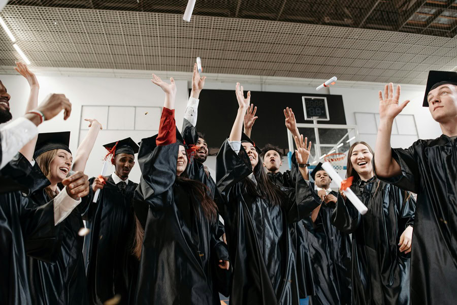 Easy Graduation Party Ideas A Group of Graduates in Caps and Gowns Throwing Up Papers