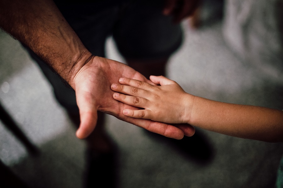 Funny Fathers Day Quotes Close Up of a Father Holding Out His Hand and His Child Putting Her Hand on His