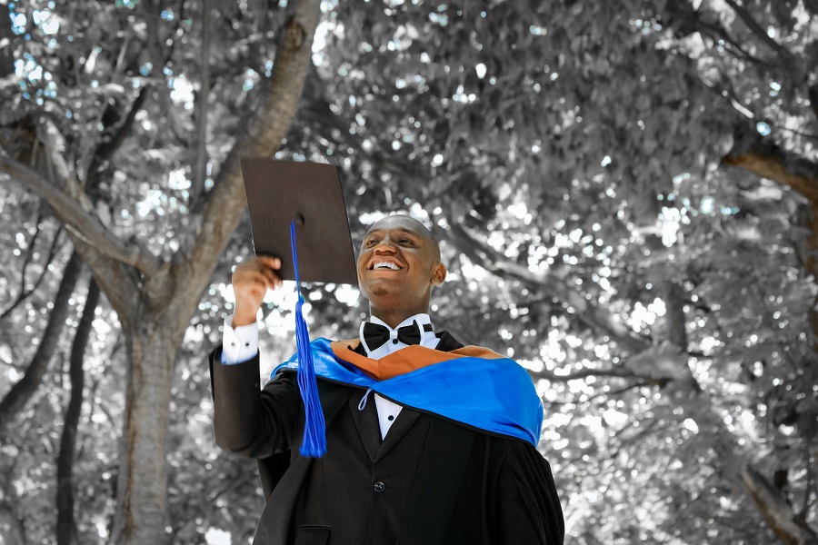 Graduation Gift Ideas a Male Graduate Smiling Holding His Graduation Cap as if He's About to Throw it in the Air