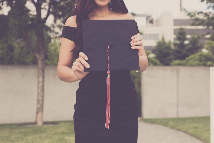 Graduation Gift Ideas Close Up of a Female Graduate Posing for a Photo in a Dress and Her Graduation Cap