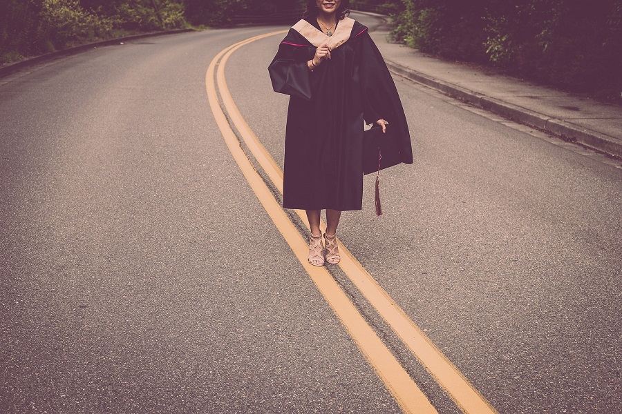 Graduation Gift Ideas a Graduate Posing for a Photo in the Middle of a Road in Her Graduation Gown