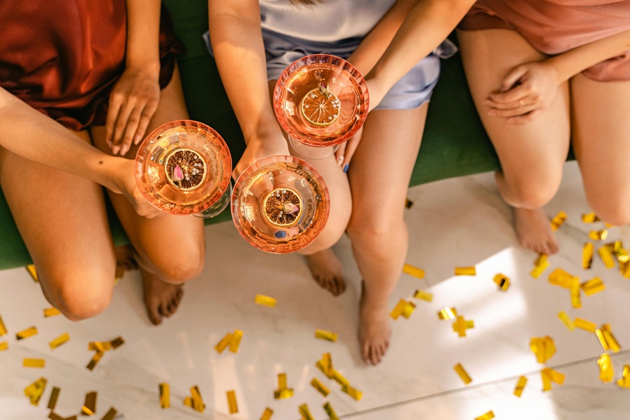 Large Batch Cocktails a Group of Women Sitting Together Holding Cocktails