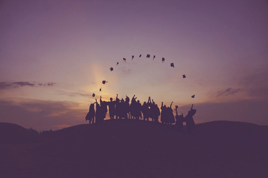 Graduation Gift Ideas Graduates Standing on a Hill in the Distance Throwing Their Graduation Caps in the Air