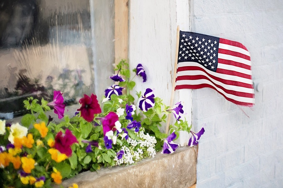 DIY 4th Of July Wreaths View of a Window Planter with an American Flag Sticking Out of it