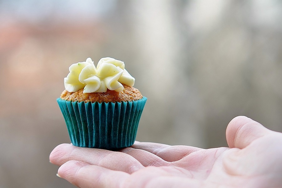 Summer Cupcakes Close Up of a Person's Hand with a Single Cupcake Sitting on Their Palm