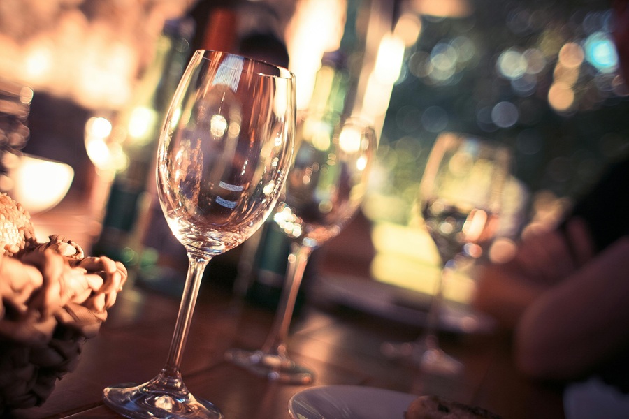 Summer Dinner Party Tips Close Up of a Row of Wine Glasses on a Set Table