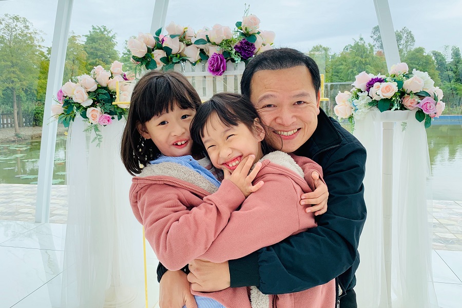 Fathers Day Gift DIYs a Father Hugging His Two Daughters