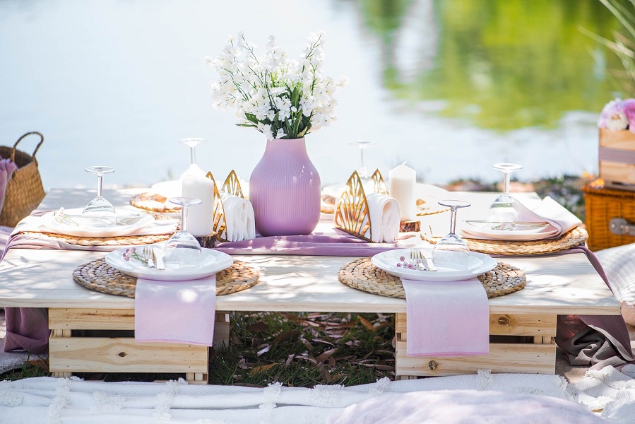 Summer Dinner Party Tips View of a Table Set Outdoors for a Dinner Party