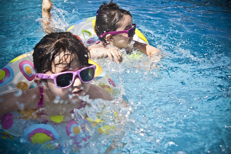 Pool Area Decorating Ideas Kids Swimming in a Pool with Floaties