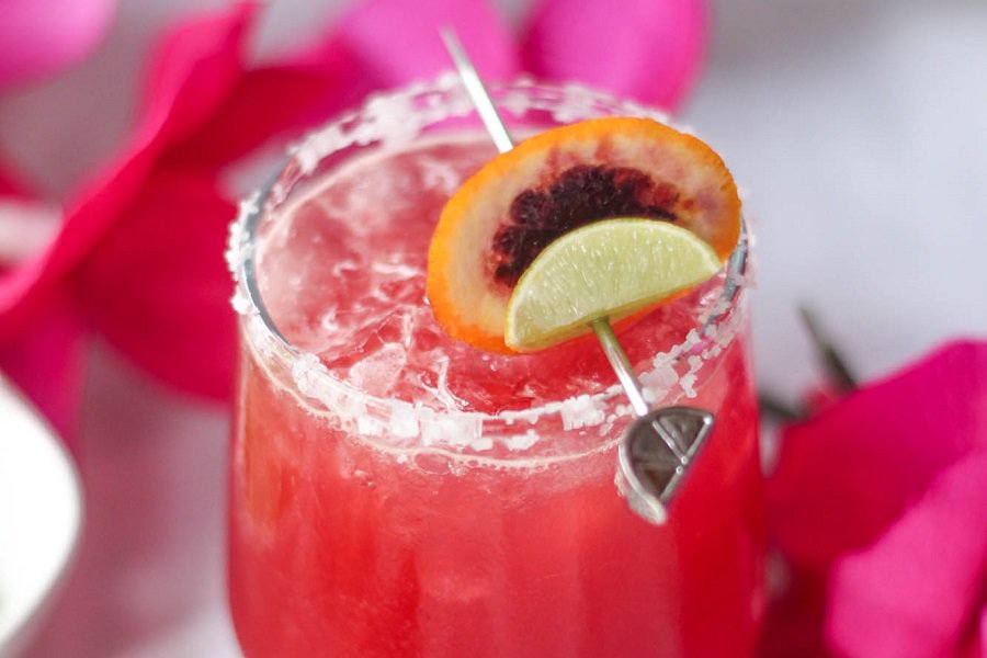 Beach Drinks with Alcohol Close Up of a Blood Orange Cocktail with Tropical Flowers Around the Glass