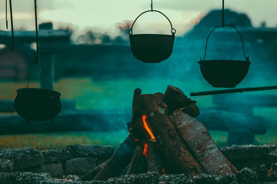 Campfire Food Ideas Two Pots Hanging Over an Open Fire Outside