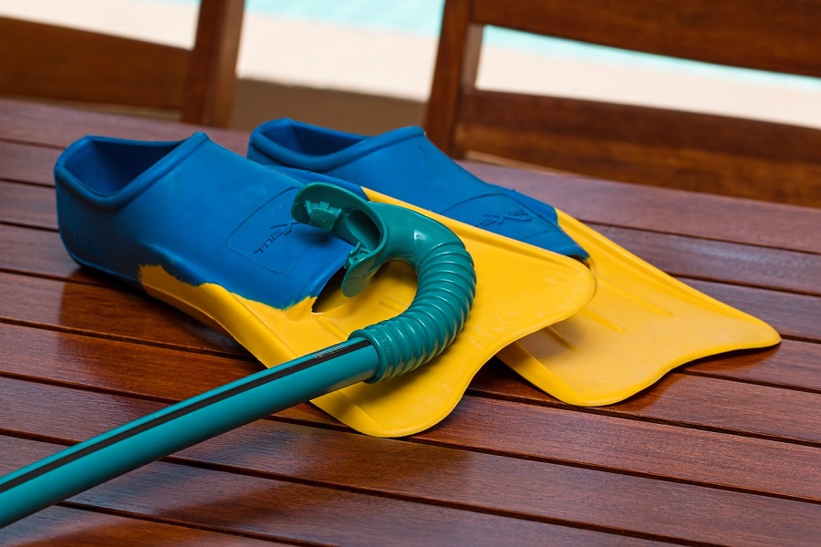 Pool Area Decorating Ideas Close-Up of Flippers and a Snorkel Sitting on a Wooden Table Outside