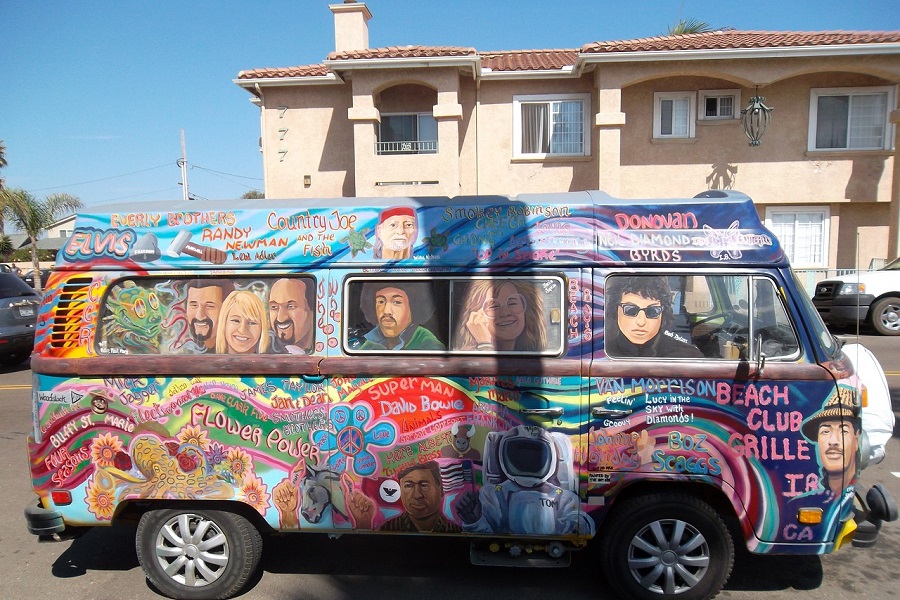 Recipes for Hippie Parties a VS Van Painted with Hippie Idols Parked Outside a Home