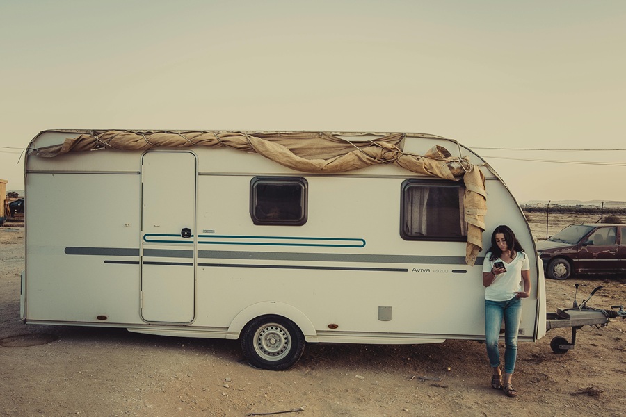 Small Camper Interior Ideas for Travelers a Person Standing Next to a Camper Trailer Outside