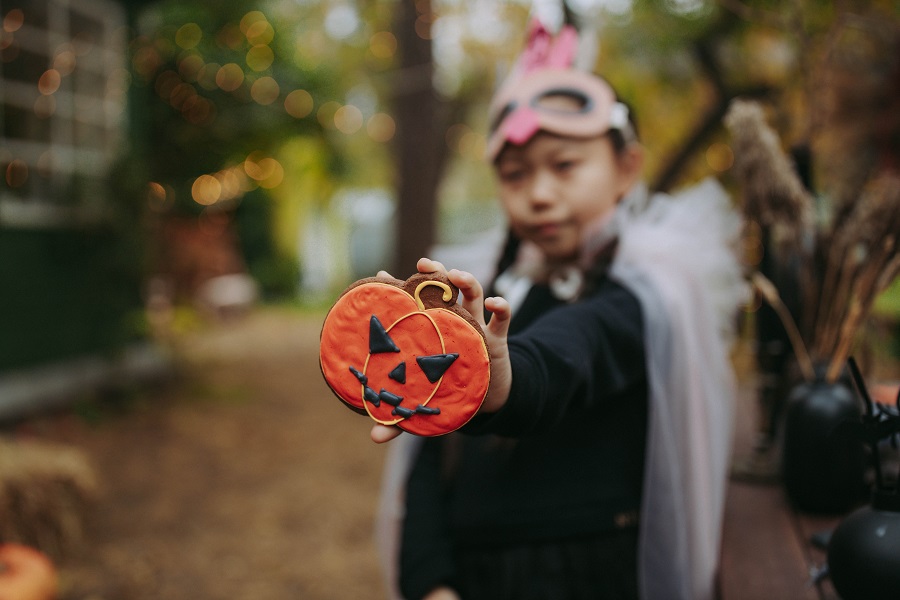 Halloween Fireplace Mantel Decor Ideas a Little Girl Dressed in a Halloween Costume Holding Out a Jack-o-Lantern Cookie