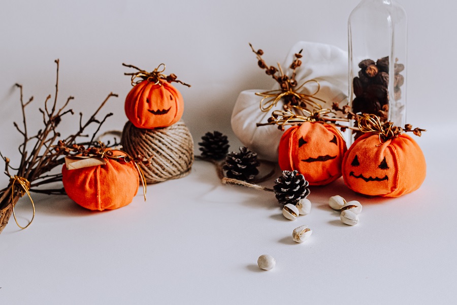 Indoor Halloween Decor Ideas Fake Jack-O-Lanterns with Scattered Crafting Supplies Behind Them