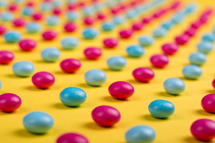 Candy Cocktail Recipes for Halloween Rows of Pink and Blue Candies on a Yellow Surface