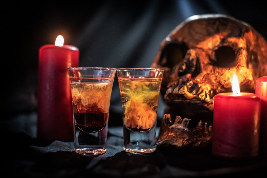 Halloween Jello Shots Recipes Close Up of Two Shots Next to a Skull and Two Red Candles