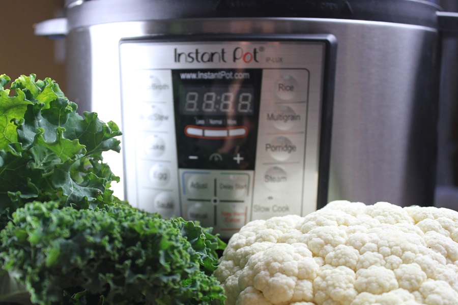 Creamy Kale Soup Recipe Close Up of a Bunch of Kale and Cauliflower in Front of an Instant Pot
