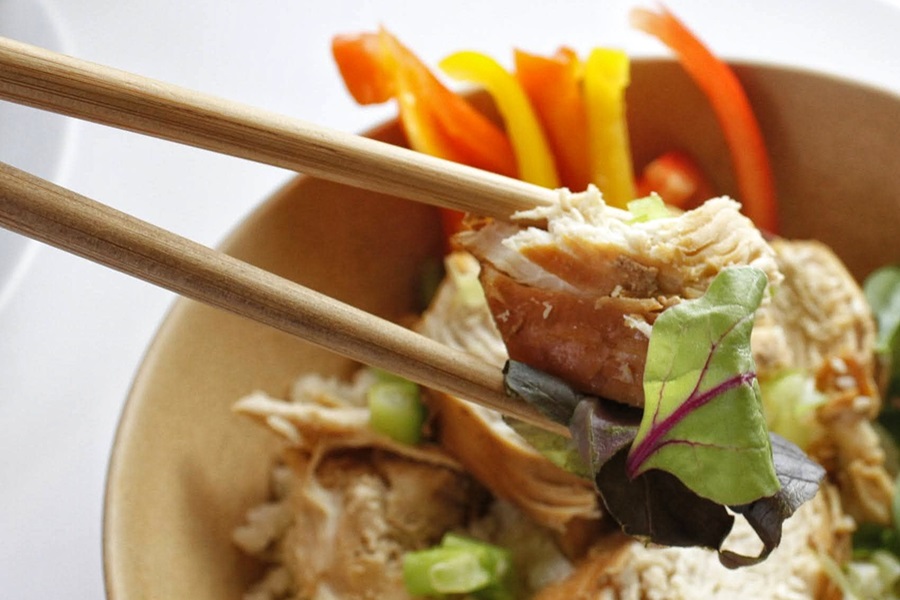 Healthy Teriyaki Chicken Recipe Close Up of a Piece of Teriyaki Chicken Being Held with Chopsticks