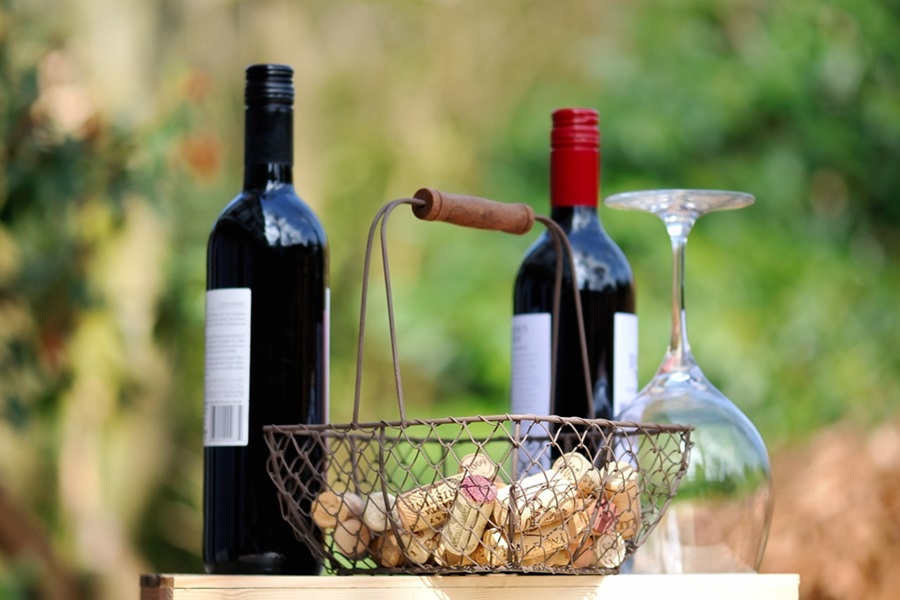 Best Coffee Wine Bar Ideas Two Bottles of Wine Next to a Small Wire Basket with Corks Inside