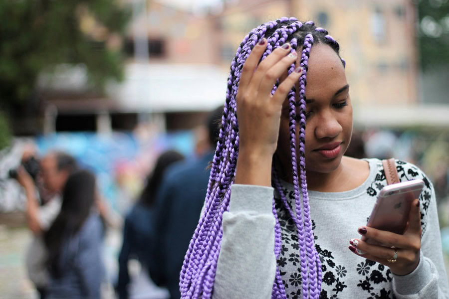 Gorgeous Goddess Braids with Curls on Natural Hair a Woman with Purple Goddess Braids Walking Outside