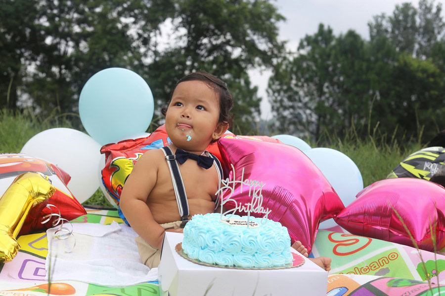 1st Birthday Party Ideas for Boys a Baby boy Sitting outside with Balloons and a Blue Cake in Front of Him and Cake All Over His Face