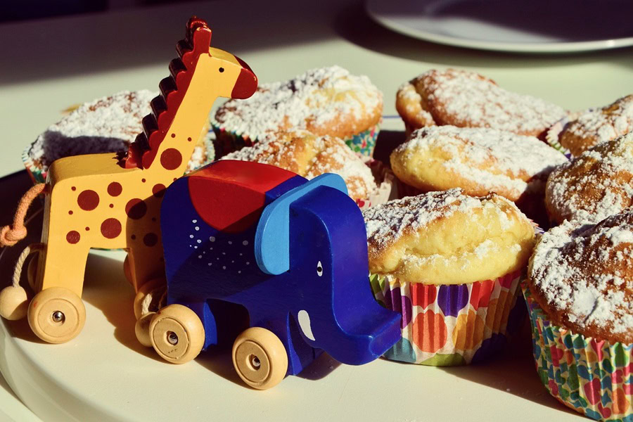 1st Birthday Party Ideas for Girls Close Up of a Tray of Cupcakes with Small Animal Toys in Front of Them