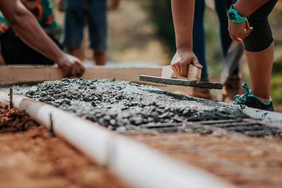 Uplifting Labor Day Quotes Close Up of Workers Laying Concrete