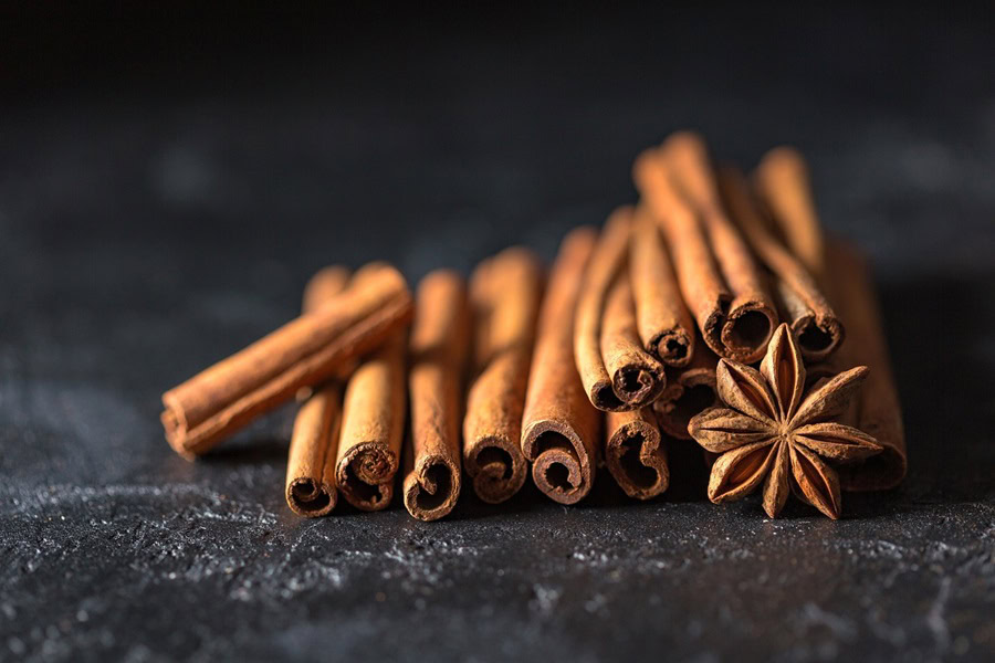 Big Batch Cocktails for Fall Close Up of a Pile of Cinnamon Sticks and a Star Anise