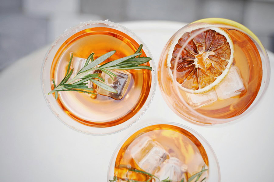 How to Batch Cocktails Overhead View of Three Cocktails Garnished with Blood Orange Slices