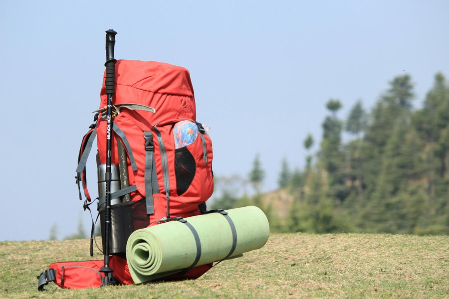 Funny Backpacking Quotes Close Up of an Orange Hiking Backpack Loaded Up with Hiking Gear