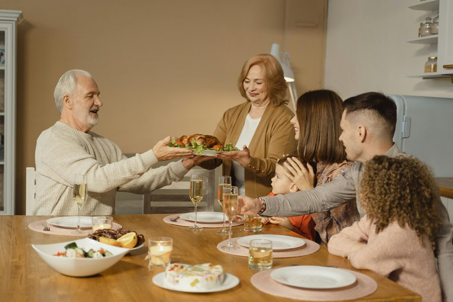 Sausage Stuffing Recipes for Thanksgiving a Family Sitting Down to Eat Thanksgiving Dinner