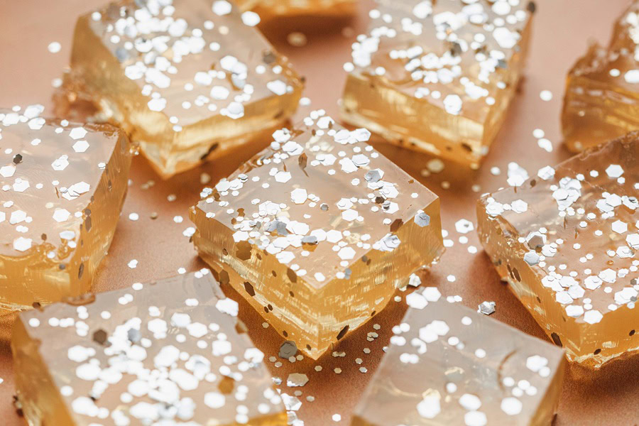 Champagne Jello Shots Recipe Angled Close Up of Jello Shot Squares on a Surface