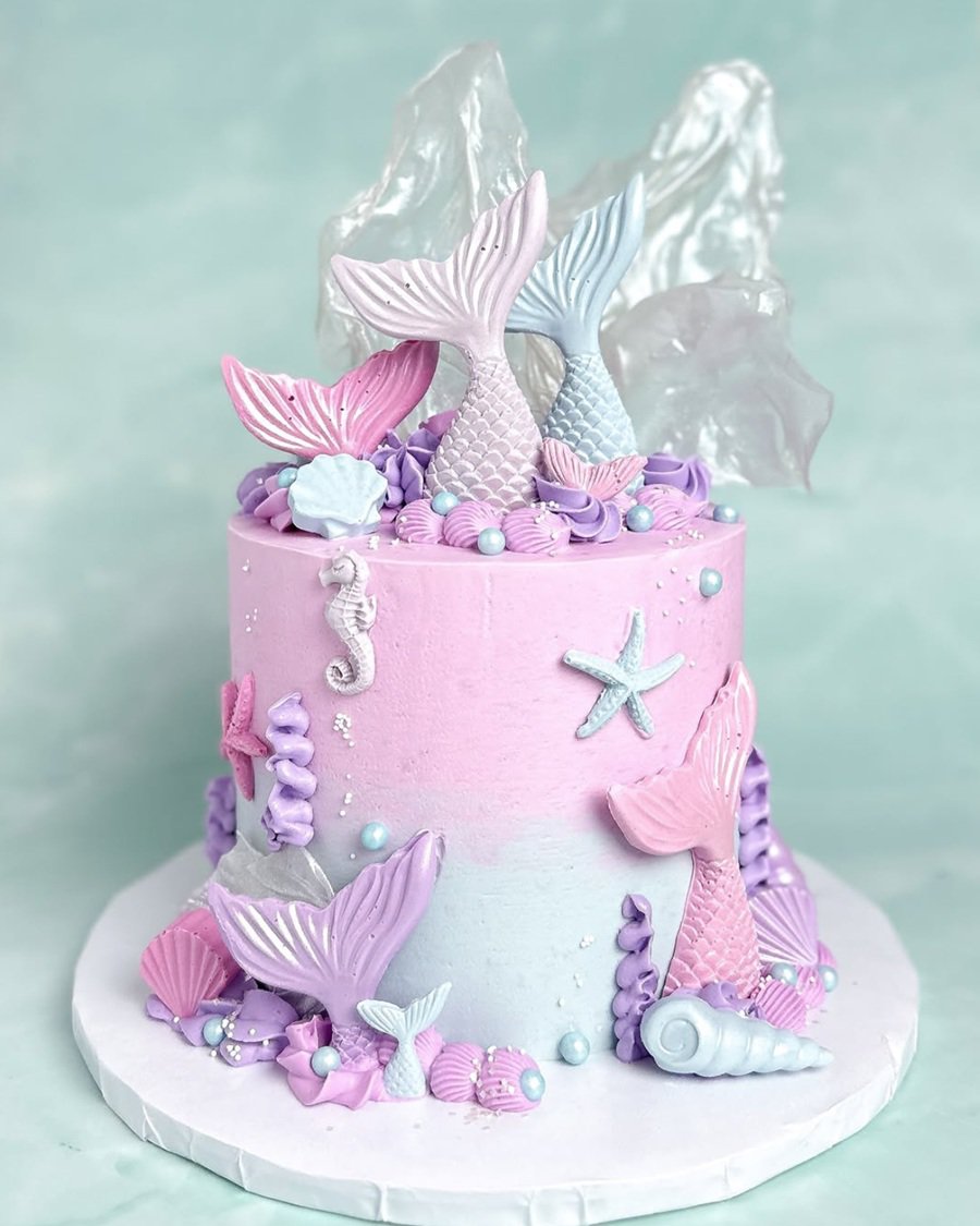 Baby Shower Cakes for Girls Close Up of a Pink and Purple Cake with Mermaid Tails