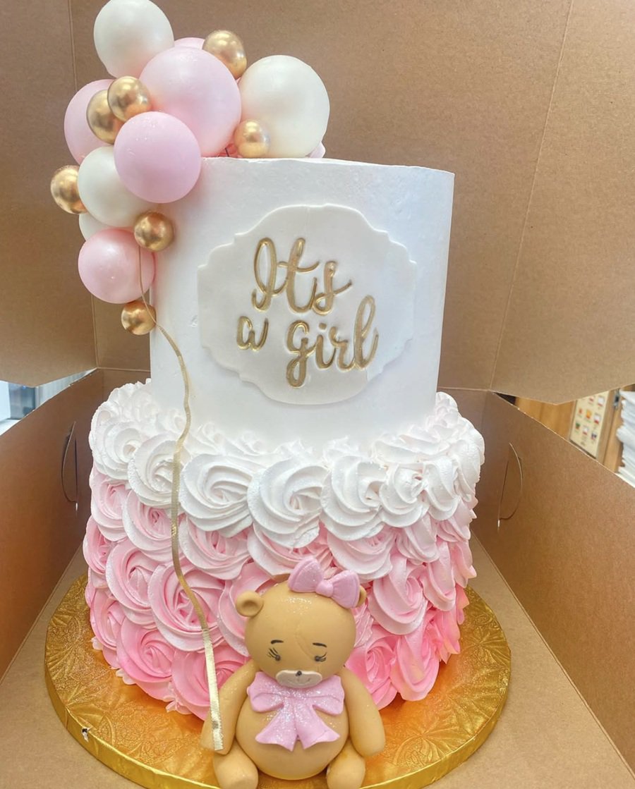 Baby Shower Cakes for Girls a Two-Tiered Cake with Ombre Pink Colors and Balloons on Top