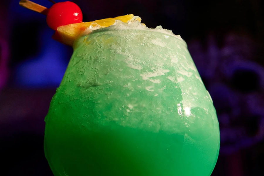 Green Cocktails for St Patricks Day Close Up of a Green Hawaiian Garnished with a Cherry