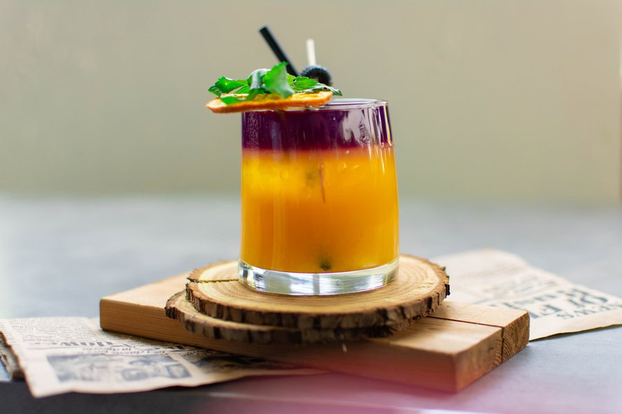 How to Make Batch Cocktails Close Up of a Cocktail Garnished with a Mint Leaf