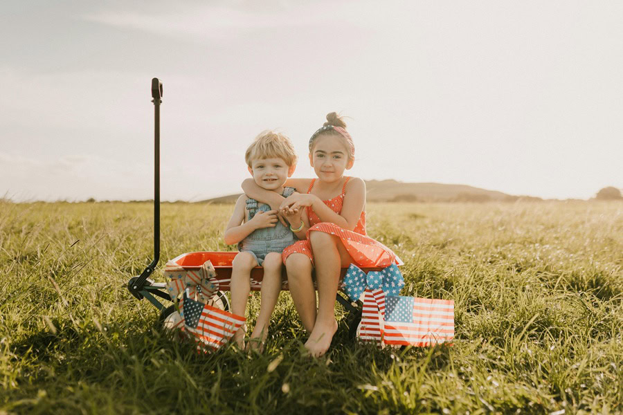 4th of July Cookies Two Young Children Sitting on a Wagon Outside Holding American Flags